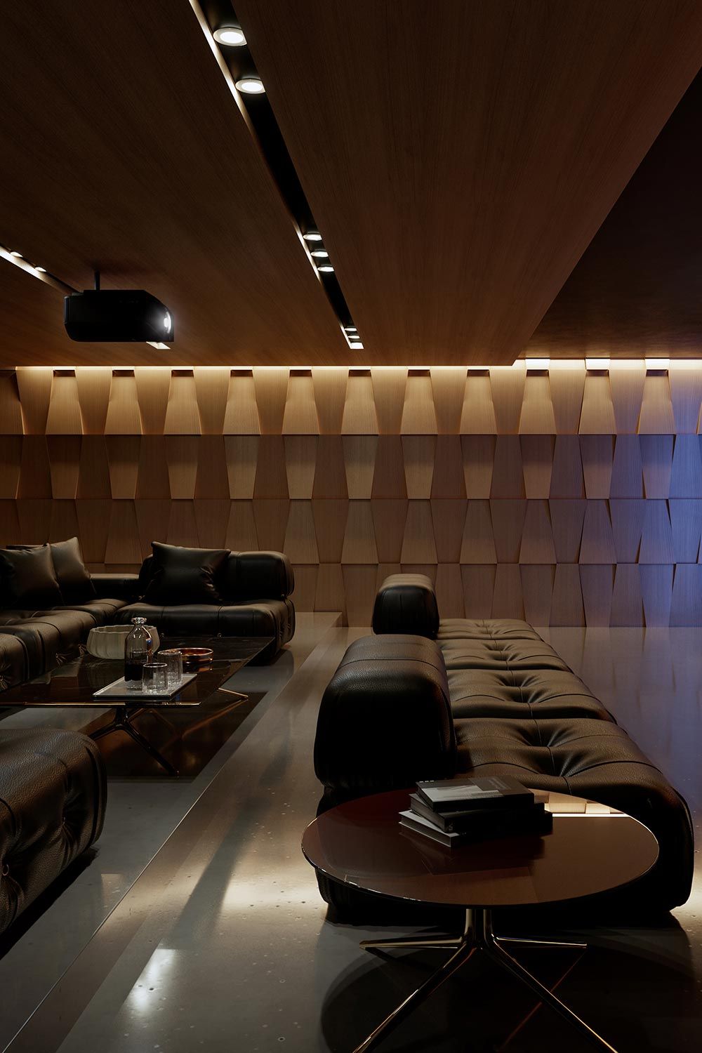 A modern home theater with black leather seating and geometric wooden wall panels for sound diffusion.