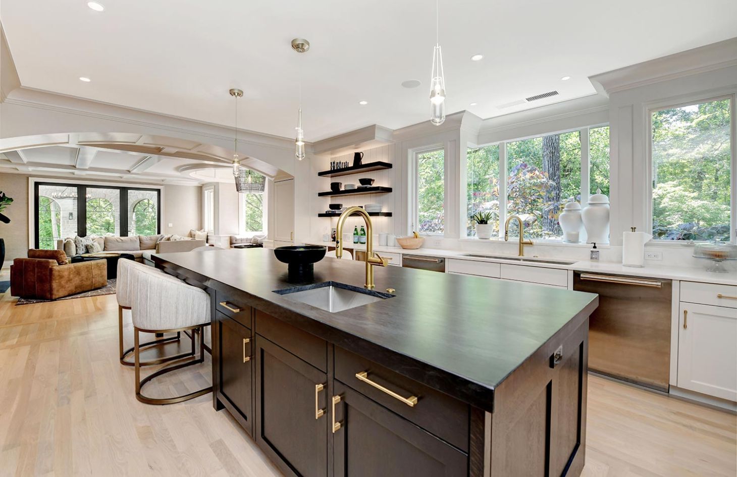 A spacious kitchen with large windows, a central island, modern fixtures, and ample natural light flowing into the room.