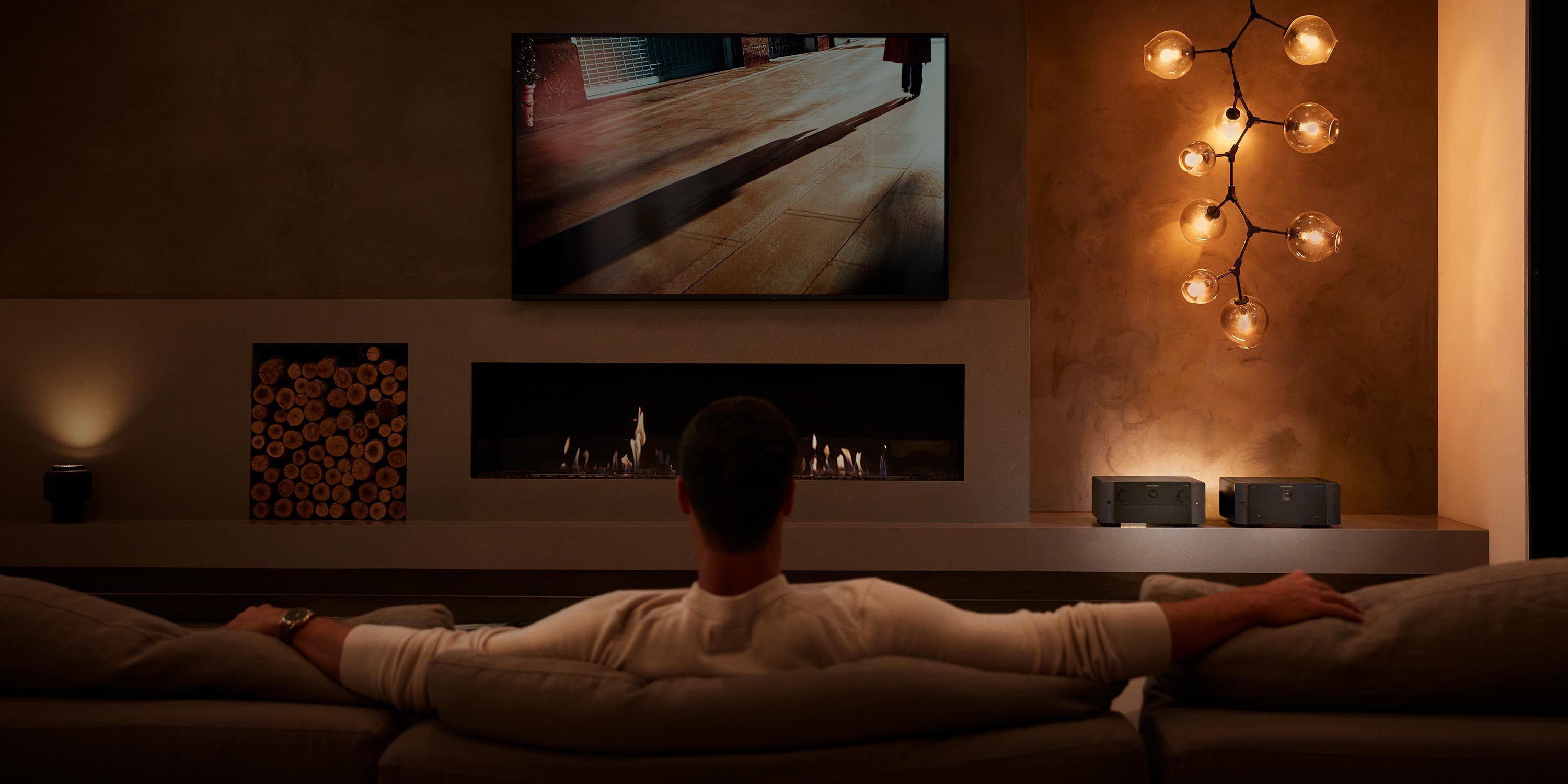 Cozy media room with a fireplace, ambient lighting, and a large screen for an immersive viewing experience.