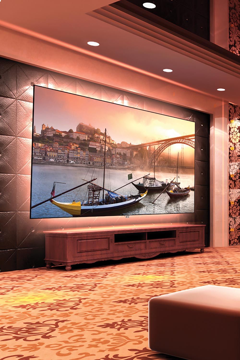 A luxurious home theater with a large screen displaying a scenic image of boats on a river.